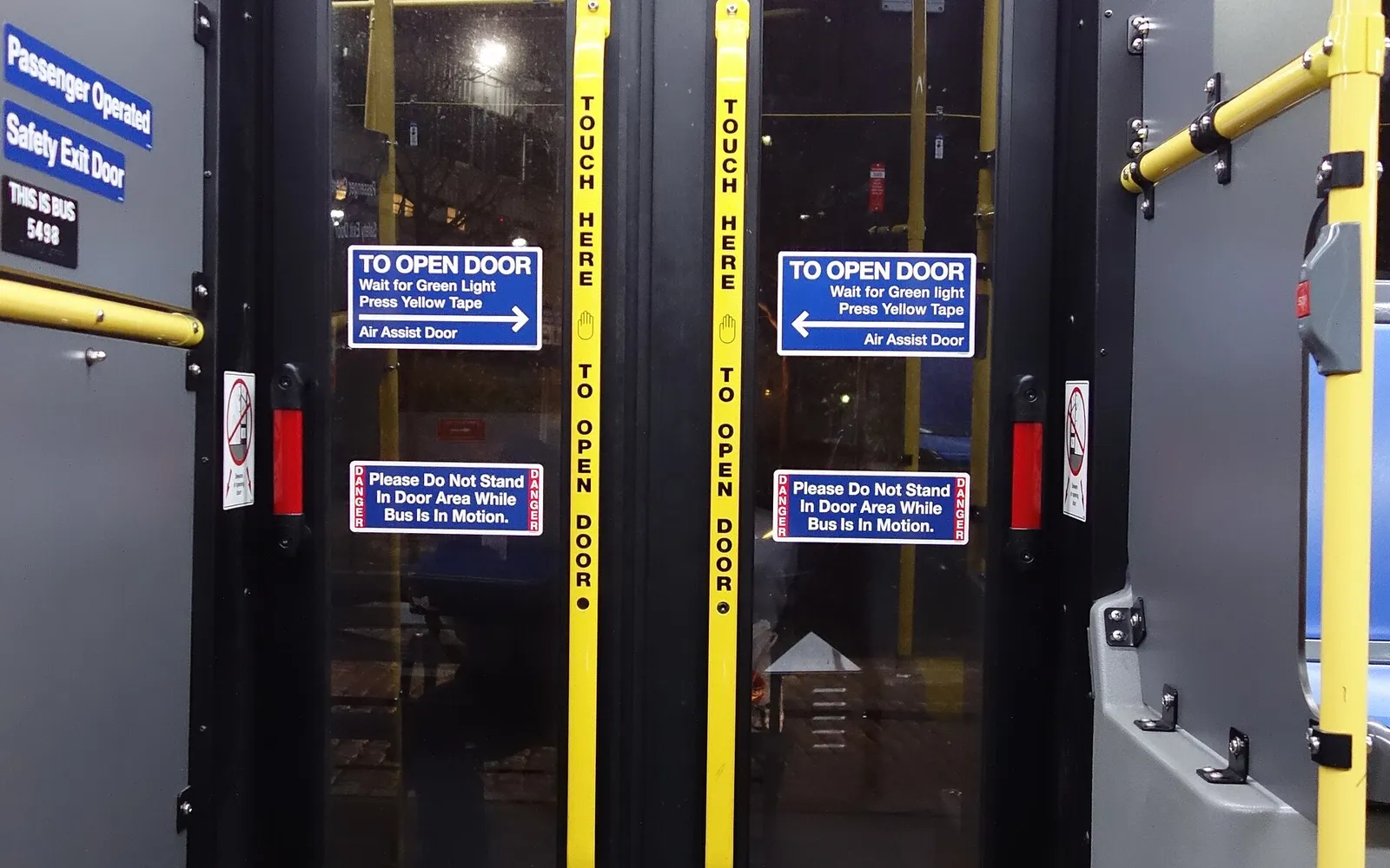 A door control marked so anyone can open it, the kind of large control this page keeps easy to reach.