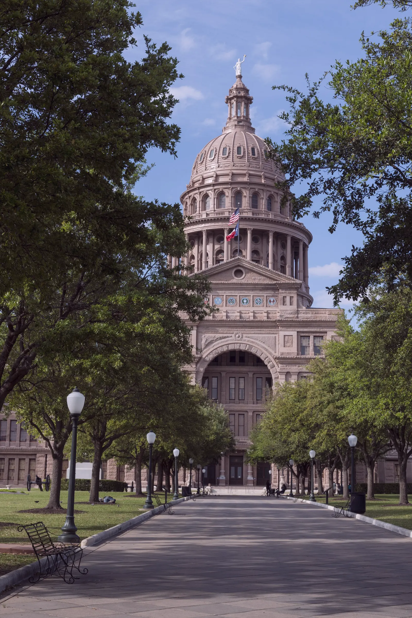 The Texas State Capitol in Austin, a granite dome and a straight walk, photographed in daylight.